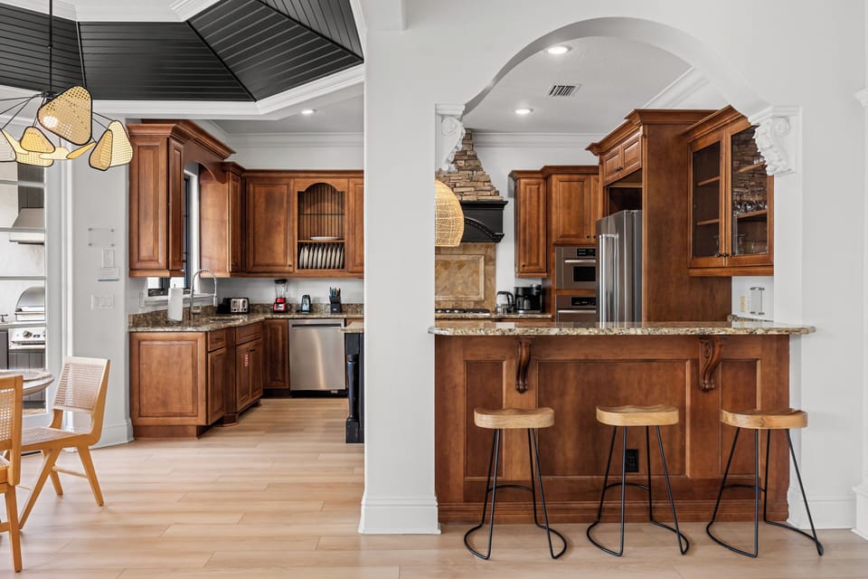 A three-seat breakfast bar provides a casual spot to grab a bite.