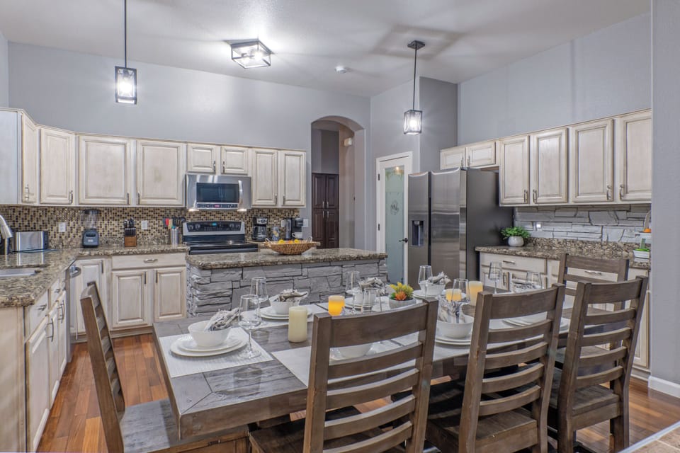 Completely stocked, modern kitchen features table eating for 8.