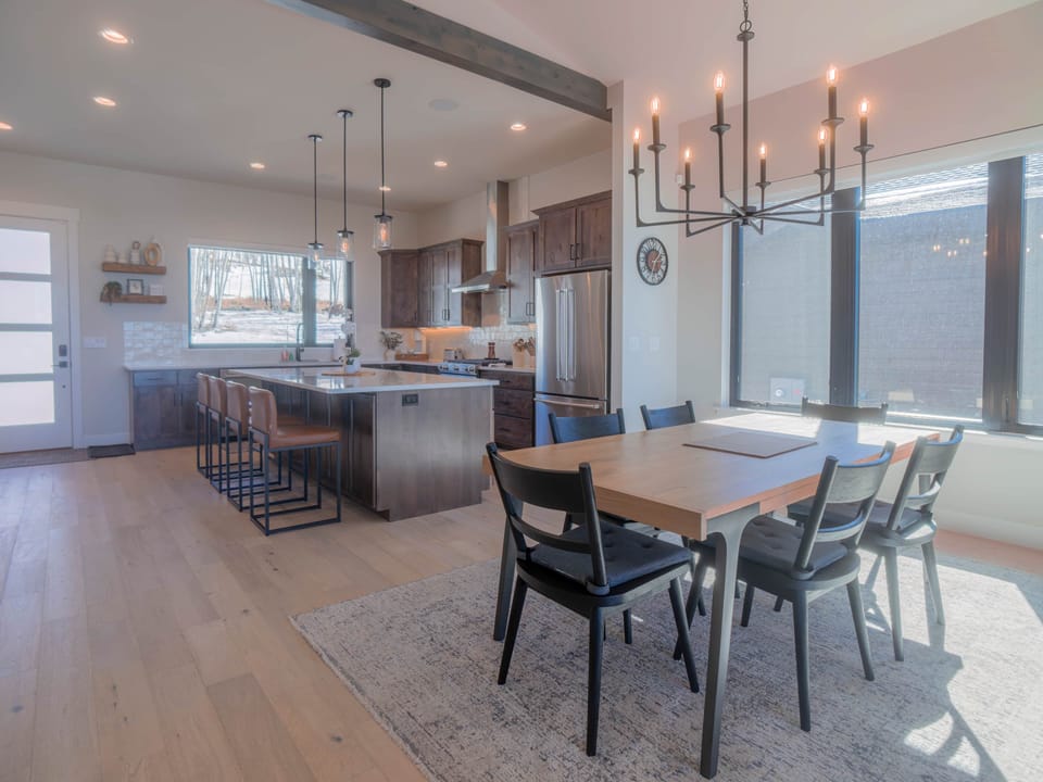 Fully equipped kitchen with modern appliances, an elegant island, and ski run views of Granby Ranch.