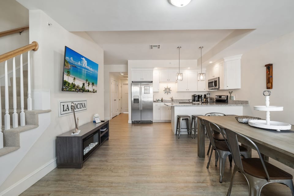 Dining room and kitchen with large smart TV