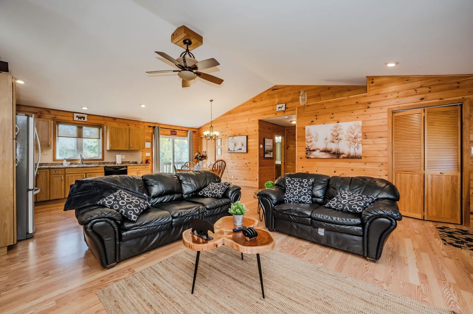 A view of the living room and kitchen, showcasing the spacious and airy design of the cottage.