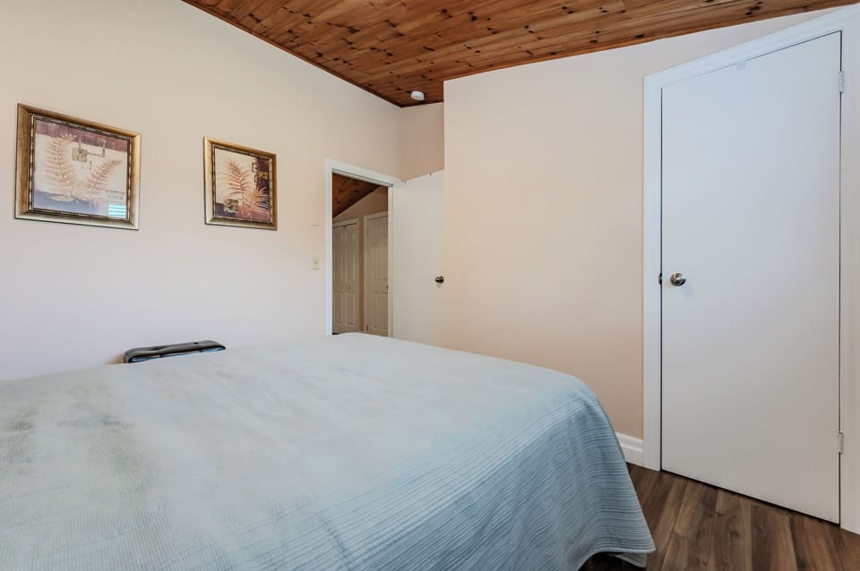 This cozy guest bedroom offers a welcoming atmosphere, ideal for a peaceful retreat after a day of adventure.