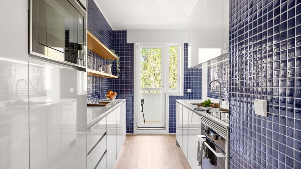 The kitchen counts with all the appliances you might need, like an oven, stove, microwave, dishwasher and even a washing machine! #modern
