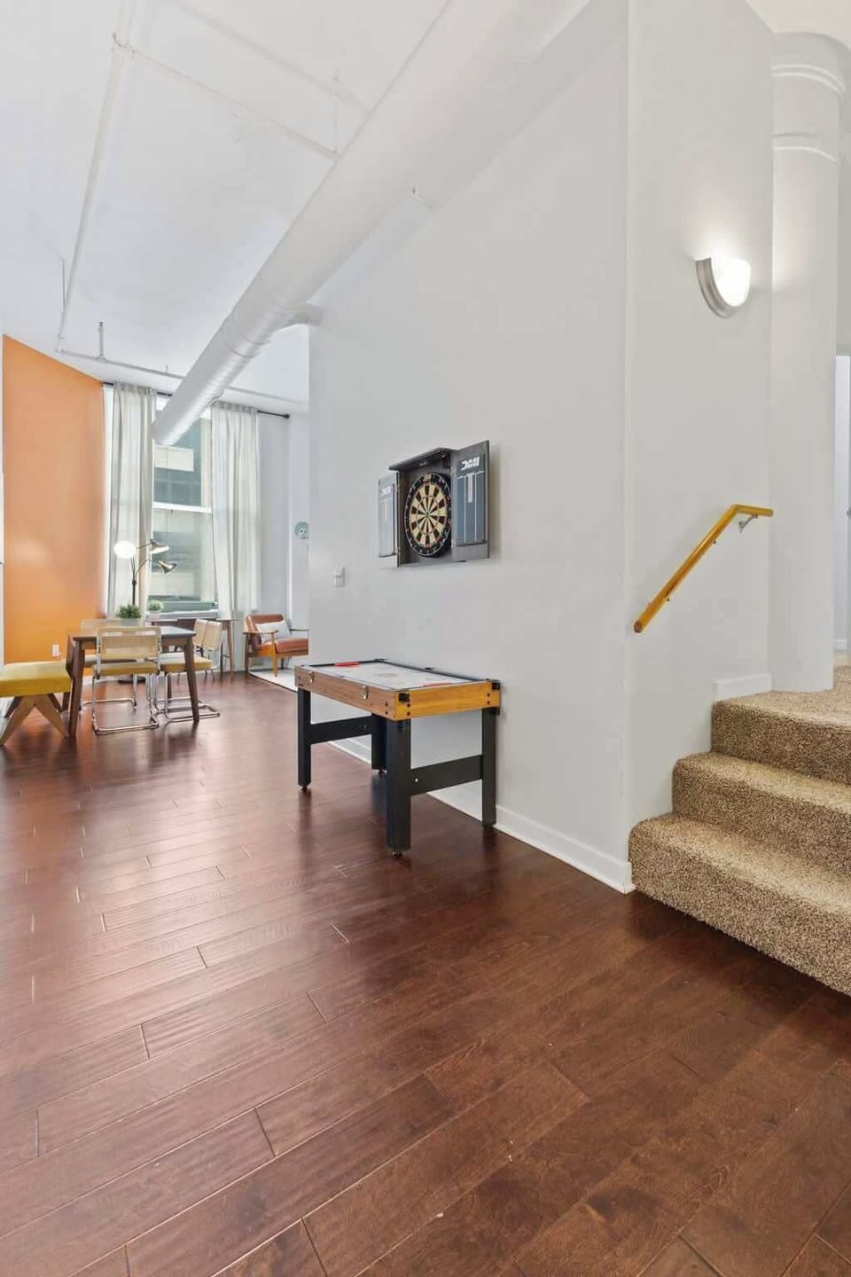 A dartboard and small game table provide fun entertainment options. Perfect for relaxing or enjoying friendly competition.