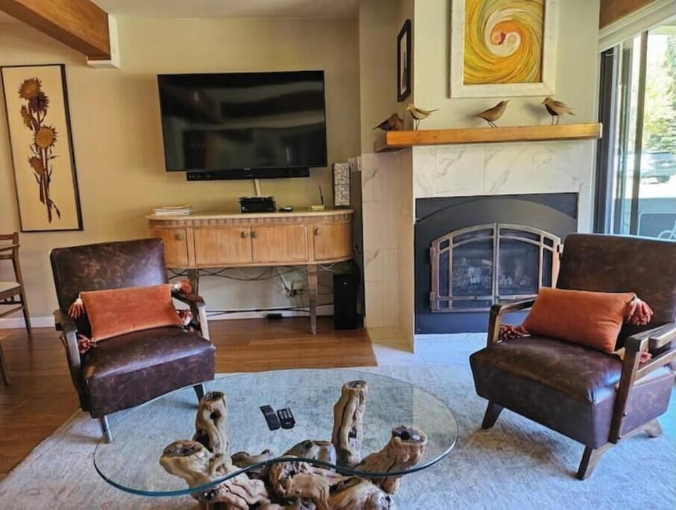 Cozy small living room with gas fireplace.  Views of the slopes from the balcony