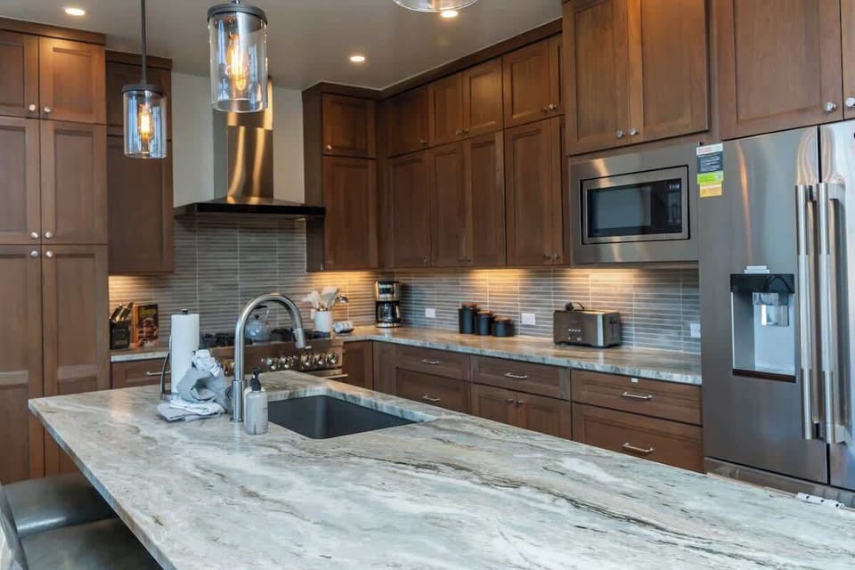 A culinary showstopper. This expansive kitchen features premium Jenn-Air appliances, custom alder cabinetry, and sleek pendant lighting—perfect for entertaining in style.