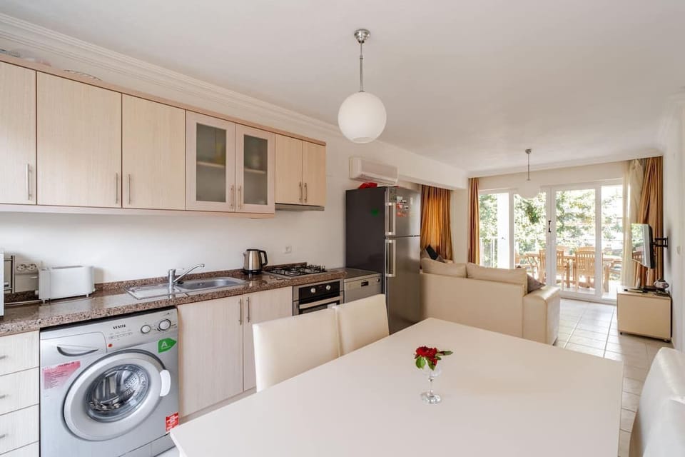 Kitchen/dining with lounge towards the patio and balcony