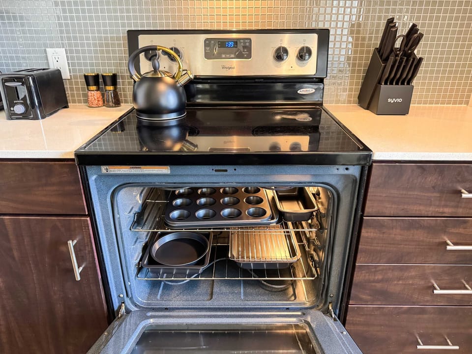 A fully equipped kitchen tailored for extended stays, complete with a sink and complimentary essentials like paper towels, dishwashing liquid, and handwash.