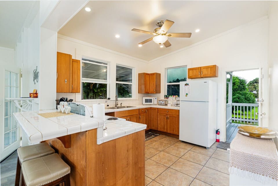 Full size kitchen with breakfast bar and door to the lanai