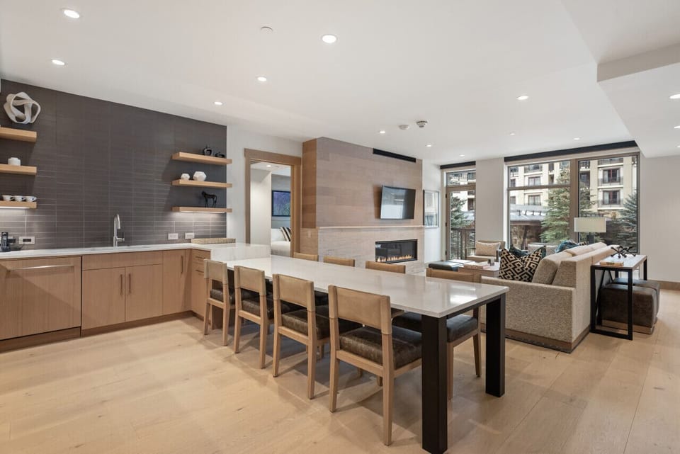 This open-concept kitchen and living room offers a seamless blend of luxury and comfort, complete with a spacious island and comfortable seating for dining or socializing.