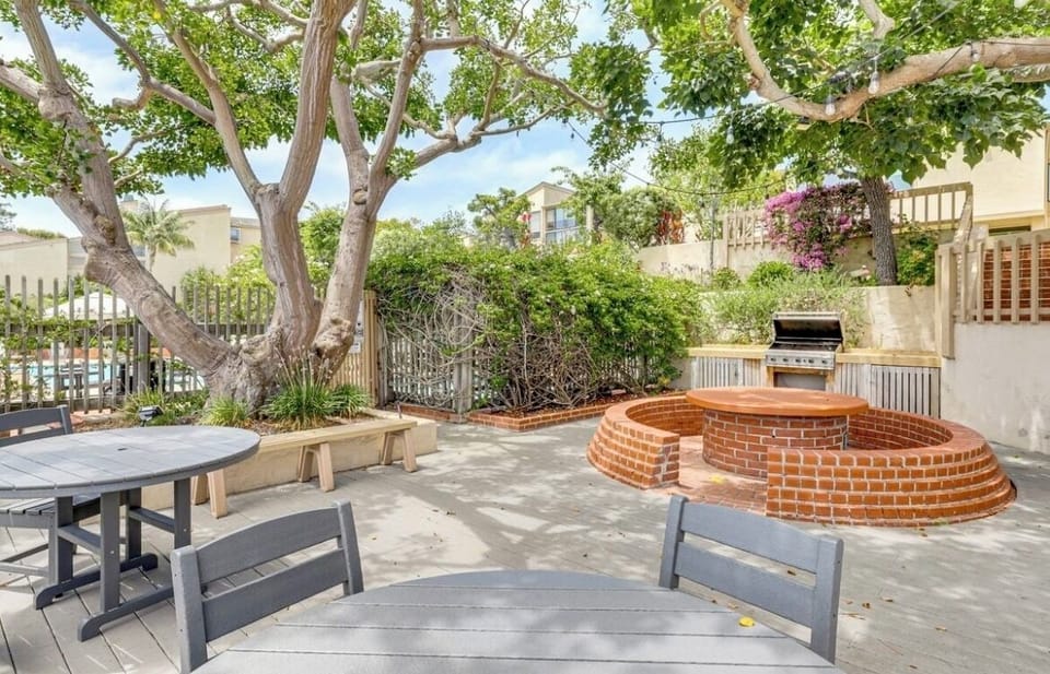 Outdoor grill + seating next to pool/tennis courts. Electric grill at the home.