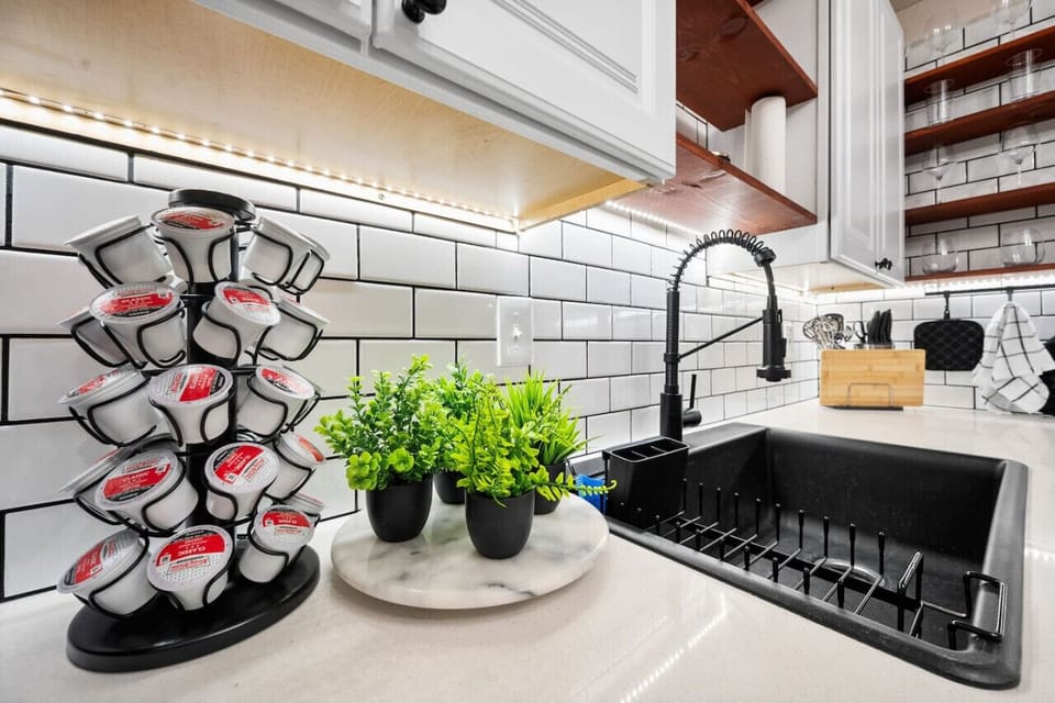 Countertop view of modernized coffee, sink, and prep area