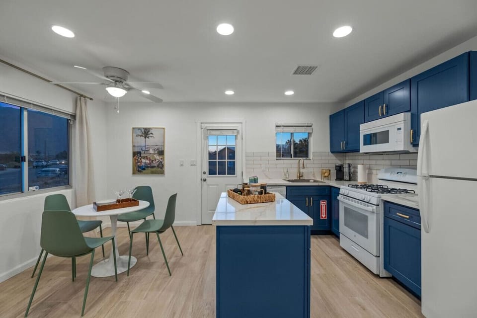 Airy kitchen and dining space w/ bar seating, perfect for quick bites or group dinners.