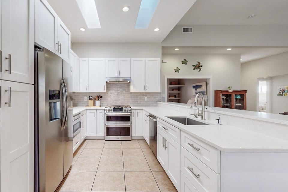 kitchen w/ 6 burner gas range and double electric oven, microwave