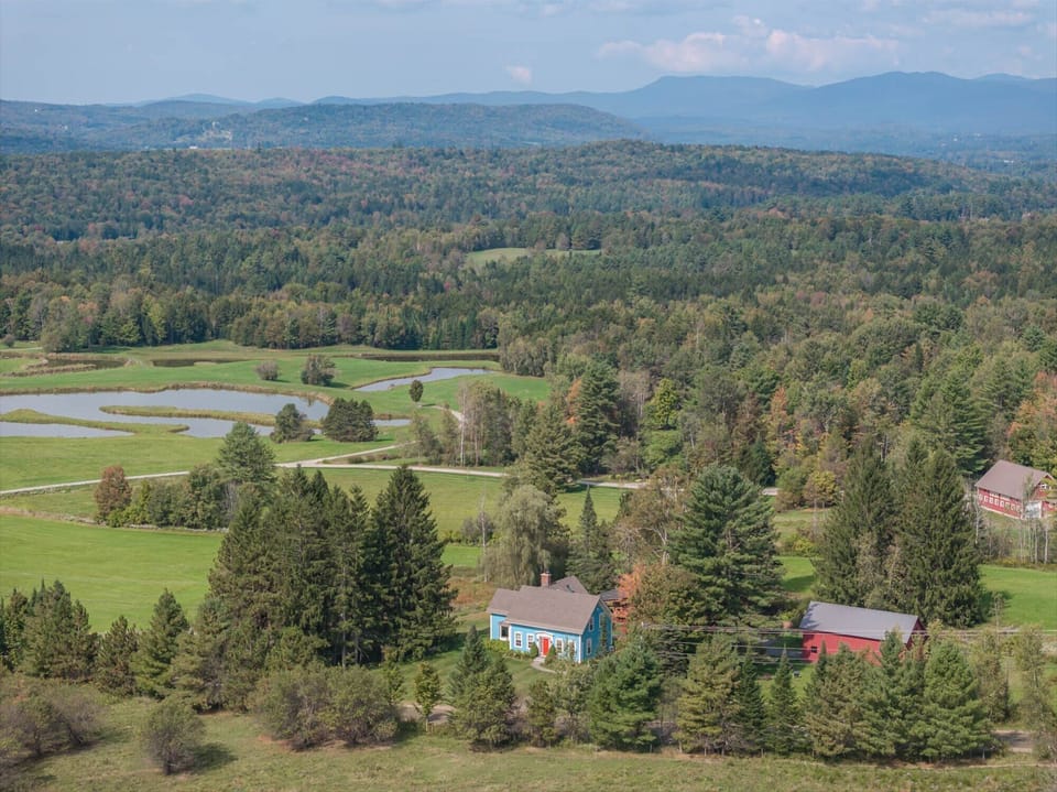 House nestled in vermont farmland.