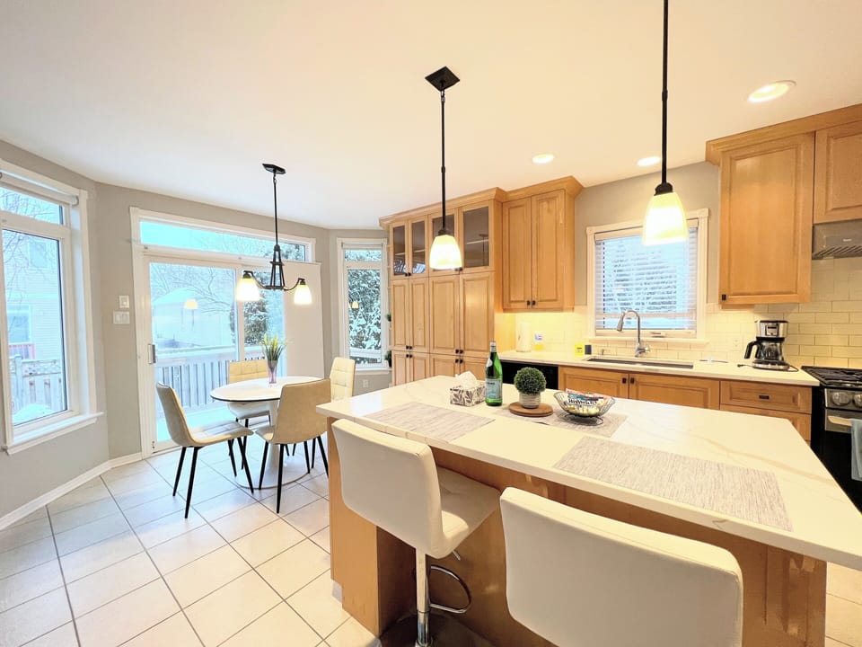 Gorgeous kitchen with large island, fridge, stove, dishwasher, stuff for cooking