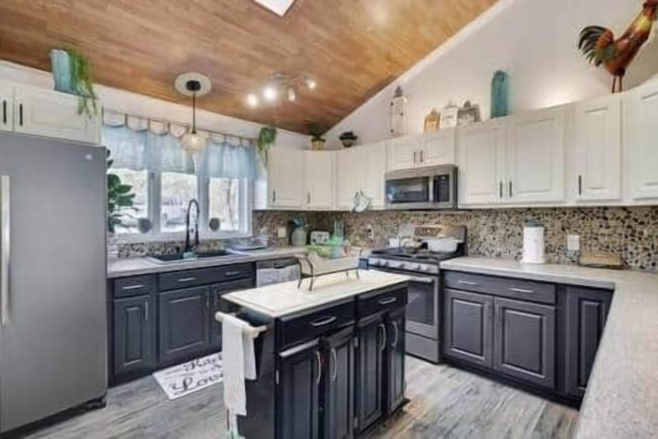 Natural light streams into the space, highlighting the beautiful backsplash.