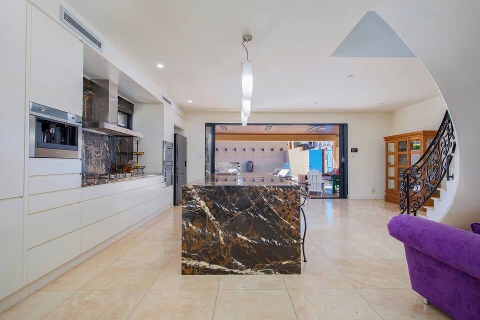 The oversized kitchen is designed around a central island and breakfast bar. 
