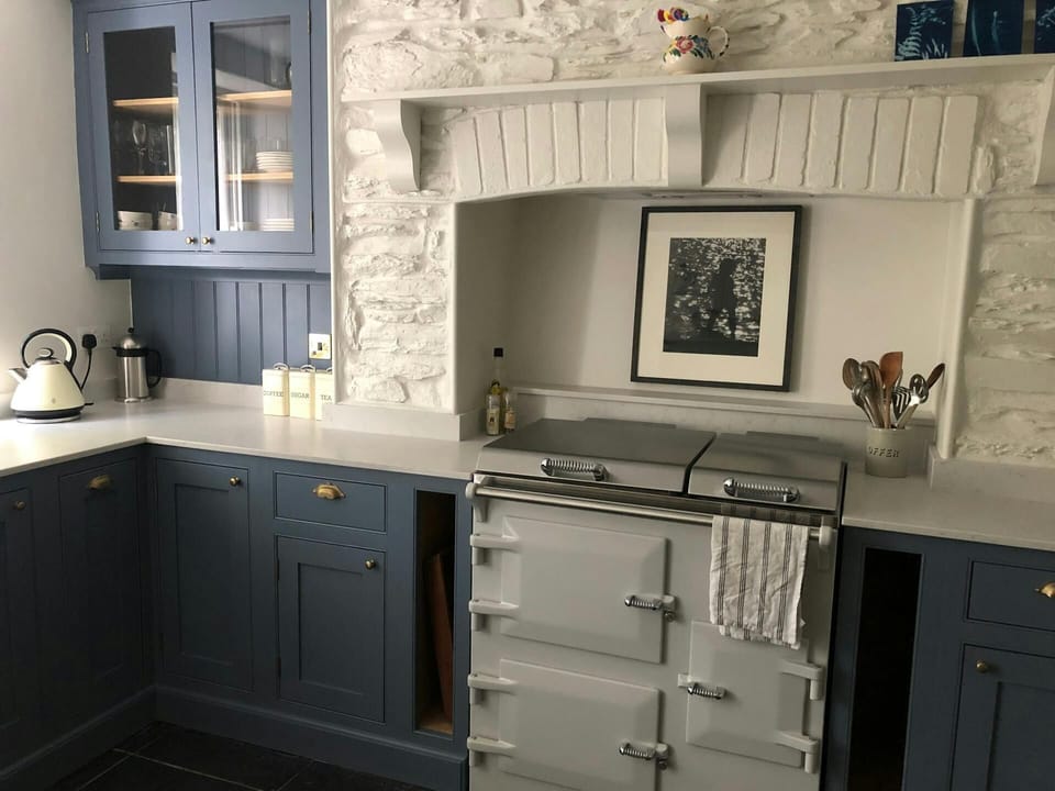 Kitchen with an induction hob and oven, and a kettle