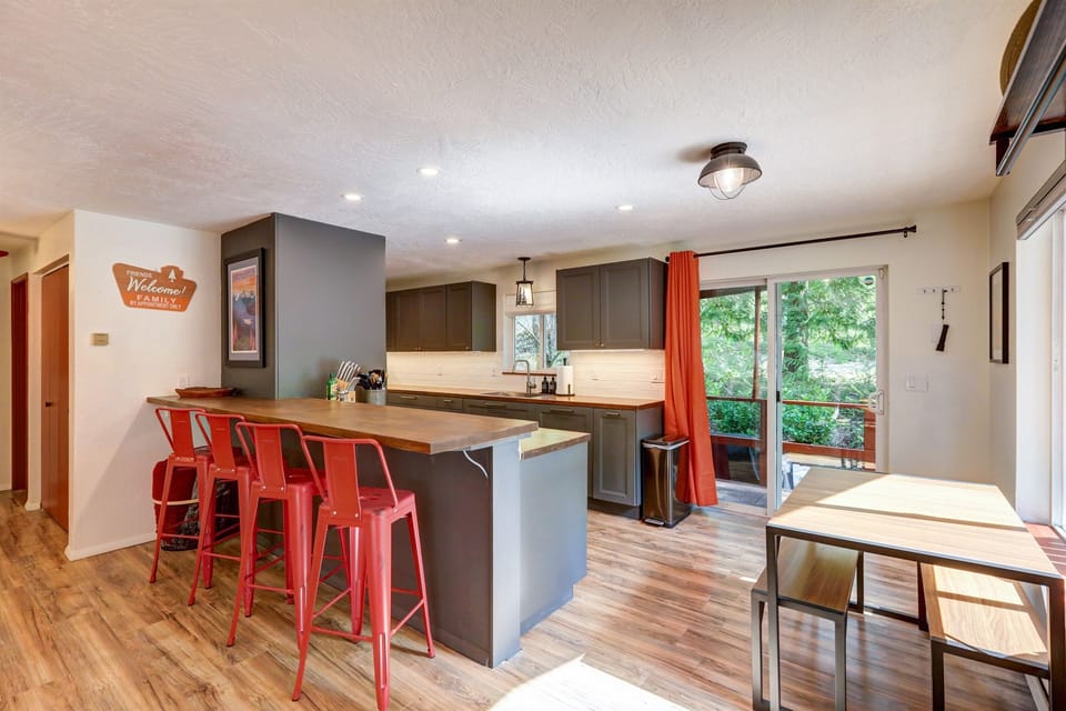 Seating for four at the breakfast bar. Slider to deck and side yard area w/ BBQ and Fire Pit area.