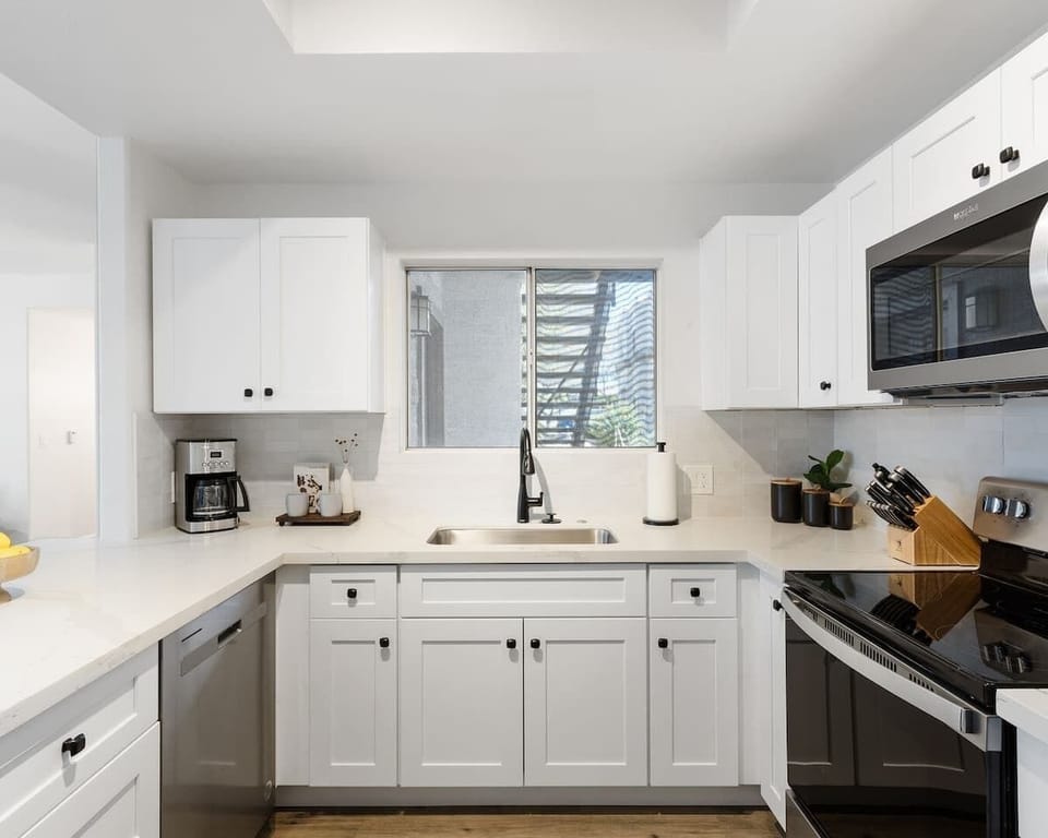 Sleek and fully equipped kitchen with stainless steel appliances, a spacious breakfast bar, and everything you need for home-cooked meals or quick snacks.