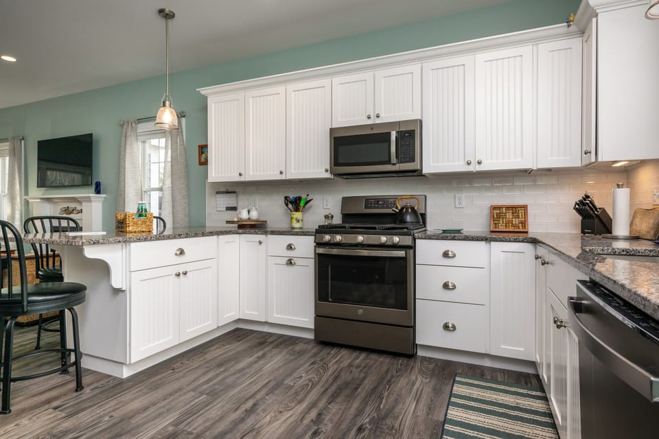 Kitchen with gas stove, microwave, stainless fridge and dishwasher
