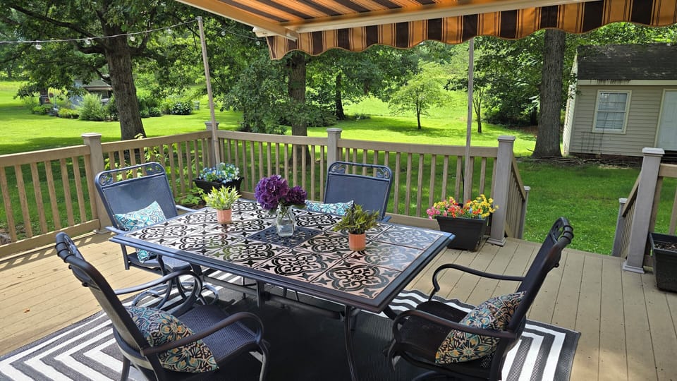 Large deck area with patio lights, grill, fire pit, deck seating for 10