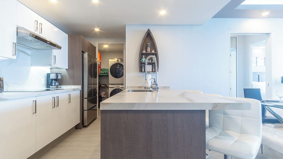 Upholstered stools are conveniently set against the kitchen counter.