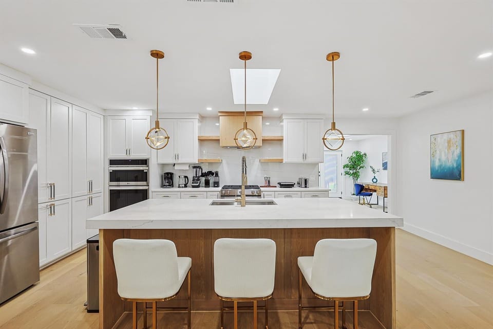 This luxury dream kitchen comes fully equipped with cooking essentials, a plethora of appliances, and a breakfast bar that provides a front-row seat of the cooking magic.