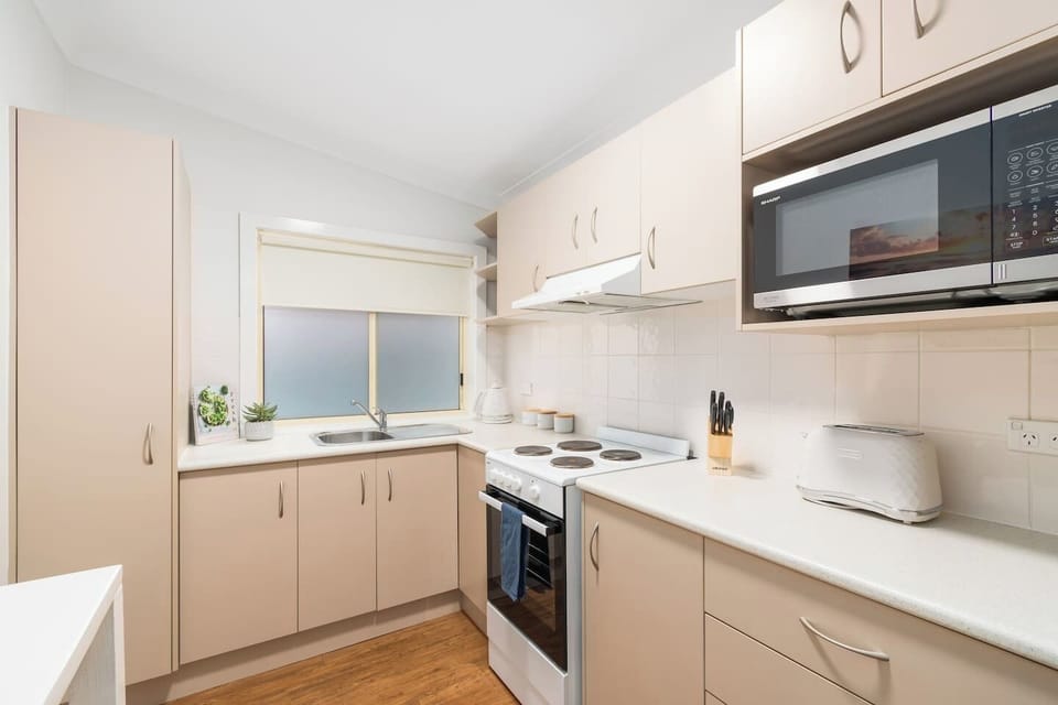 Prepare meals in this fully equipped, modern kitchen with everything you need for a comfortable stay.
