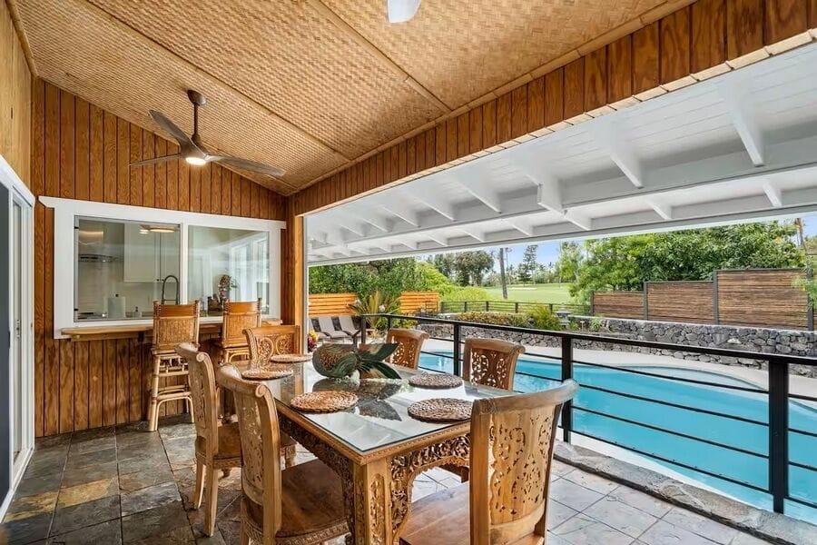 Vaulted ceilings overhead and water just beyond the lanai, where indoors meets out.