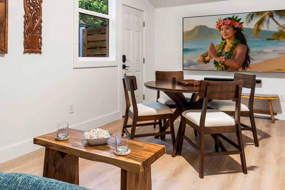 Island art and a wood table set the Boho tone in this second gathering space.