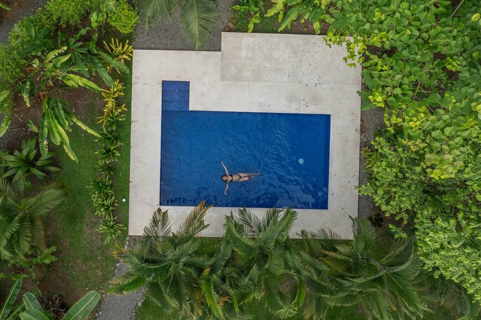 Aerial view of tropical pool surrounded by lush jungle at Tres Lodge Tucan, Playa Chiquita, Costa Rica