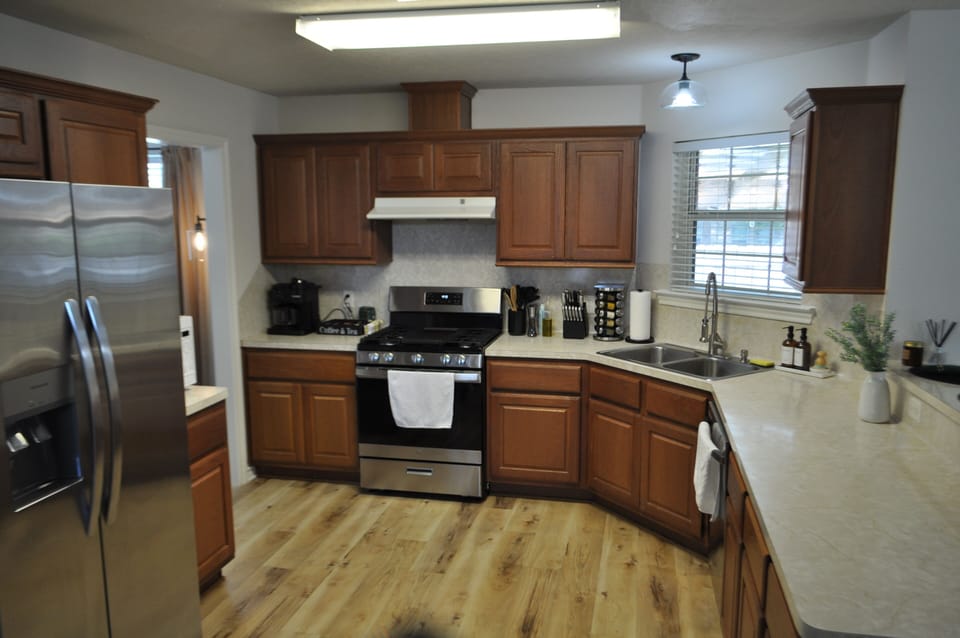 Brand new stainless steel appliances with a fully stocked kitchen