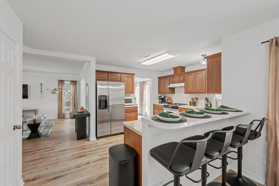 The kitchen has kitchen counter island with bar seating for 3