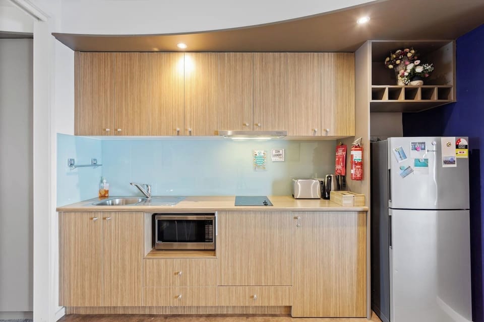A kitchen makes it easy to prepare light meals at home with a fridge, microwave and stove.
