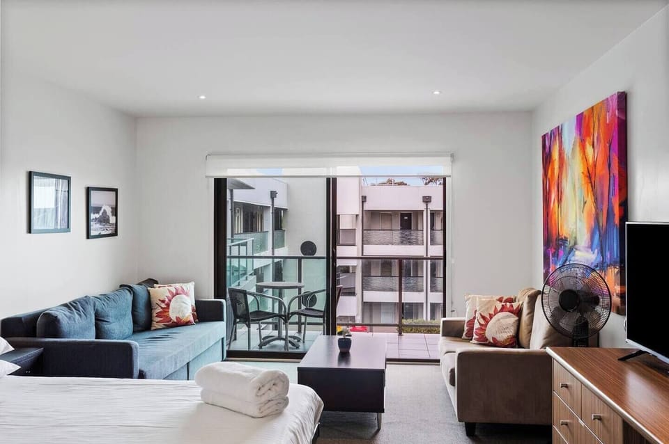 The living area flows to the balcony, creating a seamless transition between indoors and out. 
