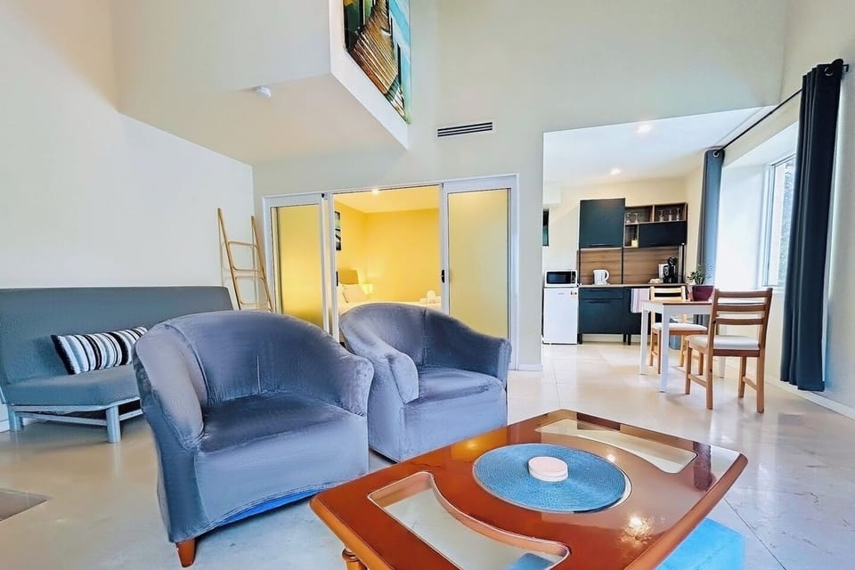 A cozy lounge area with two plush armchairs and a wooden coffee table.