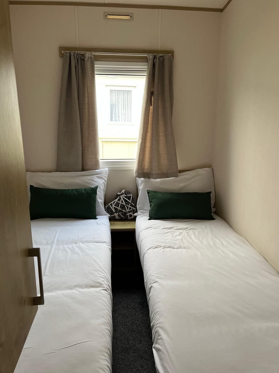 The practical layout includes twin single beds, making them ideal for children