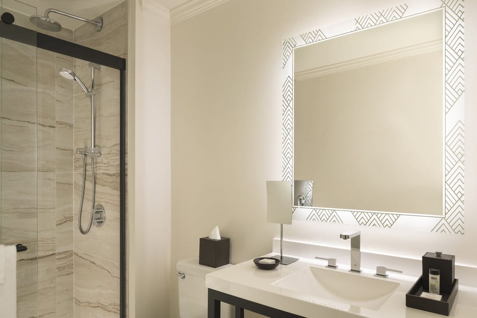 Refresh under a rain shower in a sleek, spa-like bath.