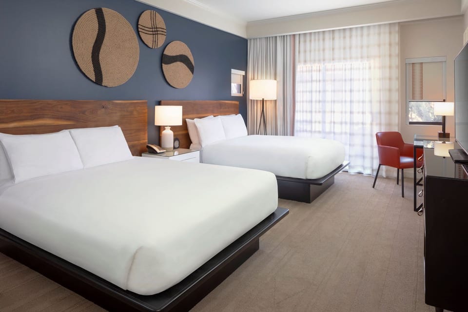 Settle into double beds with warm lighting and calm design.