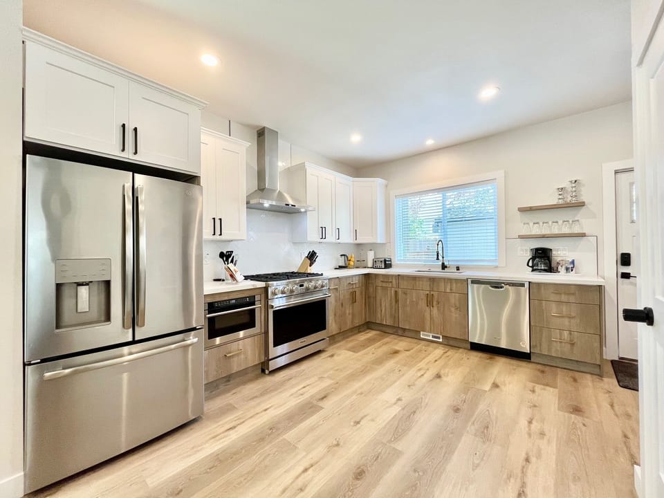Stainless steel refrigerator, stove, oven, microwave, and dishwasher.