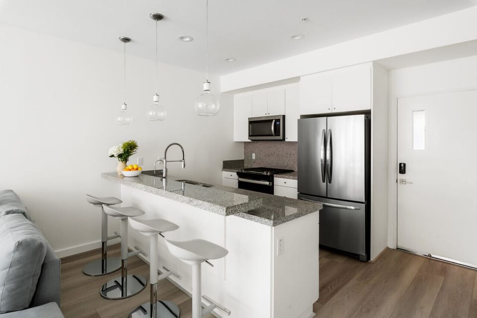 Sleek & Stylish Kitchen ✨ This modern kitchen is designed for both function and style, featuring stainless steel appliances, a granite countertop island, and chic pendant lighting. Whether you`re whipping up a gourmet meal or enjoying morning coffee at th