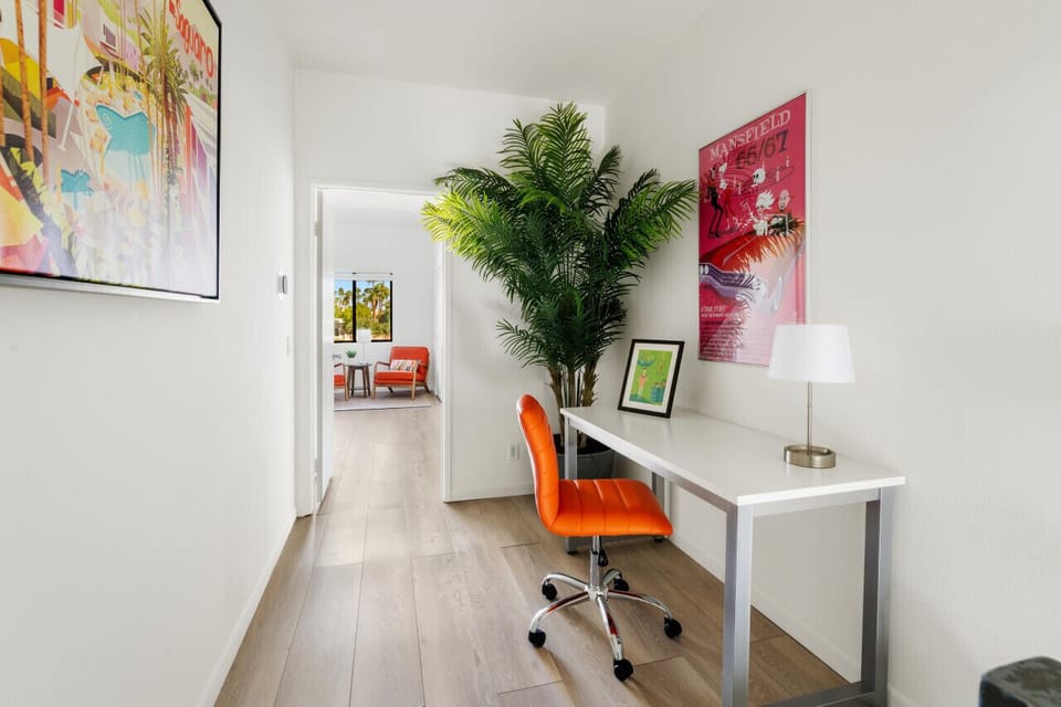 Work & Relax in Style ✨ This bright and stylish workspace blends productivity with Palm Springs charm! A sleek desk, bold pops of color, and lush greenery create the perfect spot to focus, while just steps away, a cozy lounge area invites you to unwind. 🌿