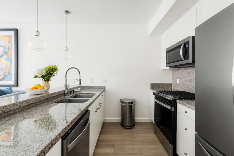 Modern Kitchen Elegance 🍽️ Step into a bright, open-concept kitchen with sleek stainless steel appliances, a spacious granite island, and stylish pendant lighting. Enjoy casual dining at the bar stools or cook with ease in this fully equipped space—perfec