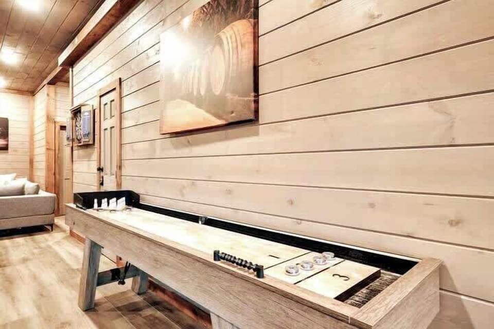 Game room in basement with Pool table, Shuffle board, Air hockey table, dart game, 23000 + Arcade game, poker table for 8, Queen Murphy Bed for extra guests, Media room with 75" smart TV, electric fireplace. 