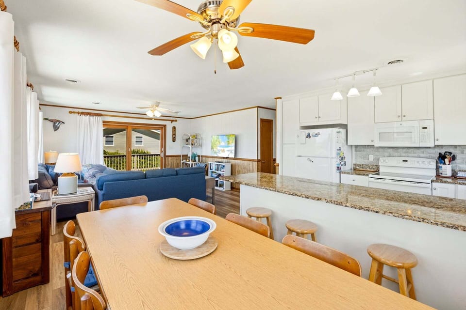 Enjoy your culinary creations in the adjacent dining area, where you can gather around the table for memorable meals together.
