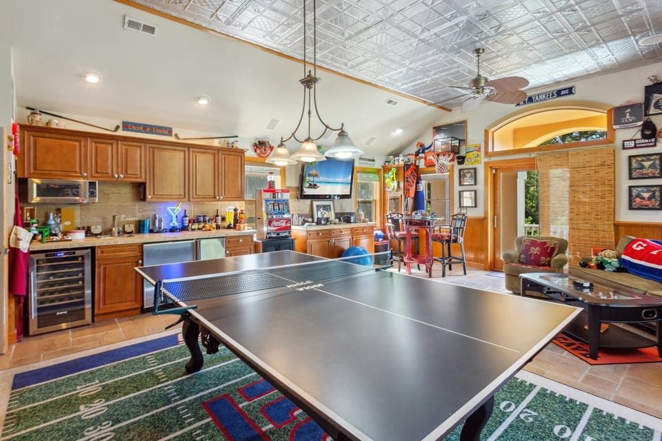 Engage in some friendly competition in the Game Room with a Ping Pong Table, Pool Table, Foosball Table, Wet Bar, and Flat Screen TV!