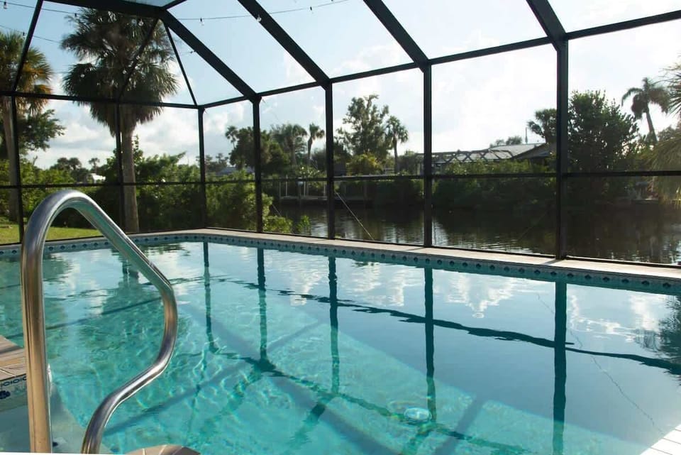"Take a refreshing dip in your own private screened-in pool, overlooking serene canal views."