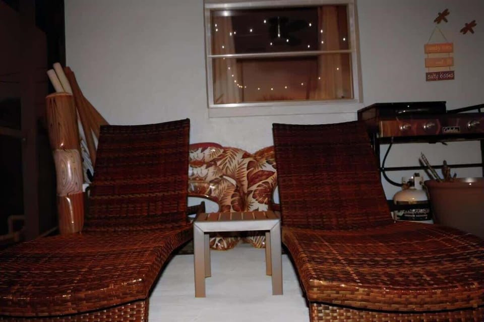 "Lounge by the pool with comfy seating, perfect for relaxation and outdoor dining."